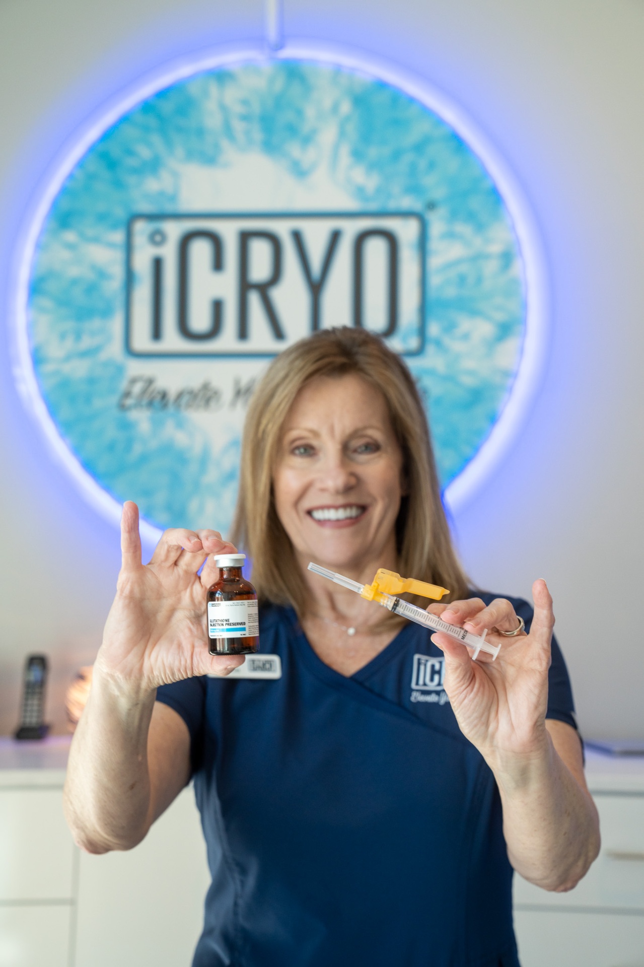 iCRYO Clemson registered nurse holding glutathione IM shot vial and syringe